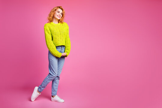 Full length photo of cute cheerful lovely girl dressed stylish clothes look empty space isolated on bright pink color background