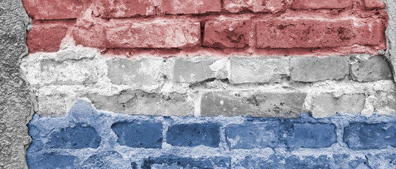 Banner with flag of Netherlands. Luxembourg national symbol on brick wall.