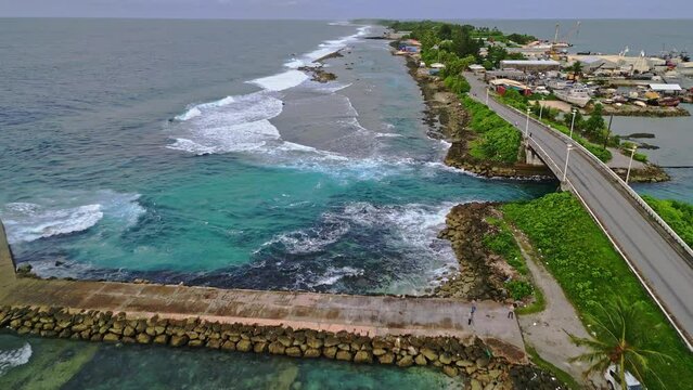 MARSHALL ISLANDS - 3.18.2024 - Amazing aerial view moving along a bridge, pier, and shoreline of Majuro in the Marshall Islands.