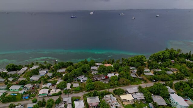 MARSHALL ISLANDS - 3.18.2024 - Great aerial panorama of houses on the coast of the Marshall Island, moving towards the water.