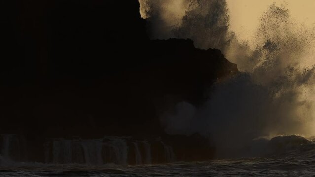 HAWAII - 3.18.2024 - Excellent slow motion view of waves crashing upon Molokai, Hawaii at sunset.