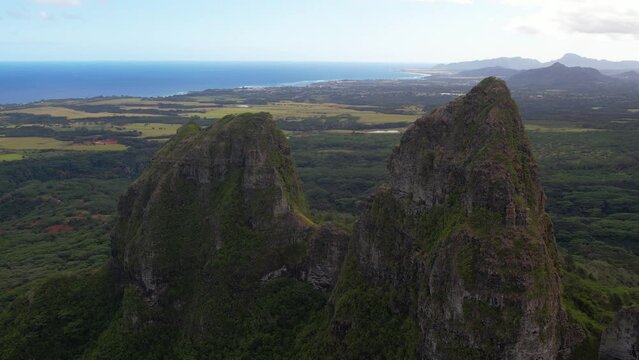 KAUAI - 3.19.2024 - Great aerial footage moving between two peaks in a green mountain range of Kauai, Hawaii.