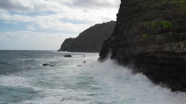 MOLOKAI - 3.19.2024 - Amazing aerial pan of waves rolling towards the shores of Molokai, Hawaii in slow motion.