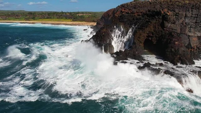 MOLOKAI - 3.19.2024 - Very good aerial footage of ocean waves crashing against the rocky shore of Molokai, Hawaii.