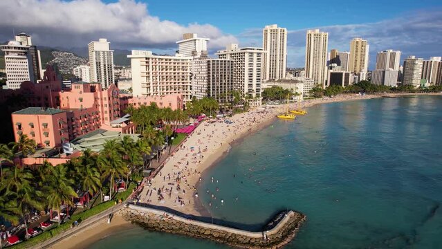 WAIKIKI - 3.19.2024 - Excellent aerial footage circling a pier and beach in Waikiki, Hawaii.