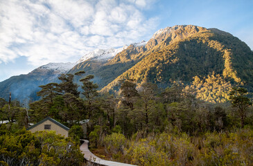 Boardwalk and huts hidden in the trees and mountains of the Milford Track hiking trail on the South Island of New Zealand