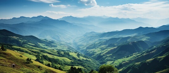 Mountain panoramic landscape with green hills and blue sky. Mountainous Green Valleys - obrazy, fototapety, plakaty