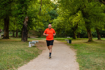 Sporty man running or jogging at the park active healthy lifestyle.