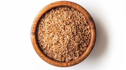 Brown rice groats in wooden bowl isolated on white background, top view