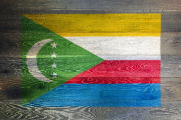 Comoros flag on rustic old wood surface background