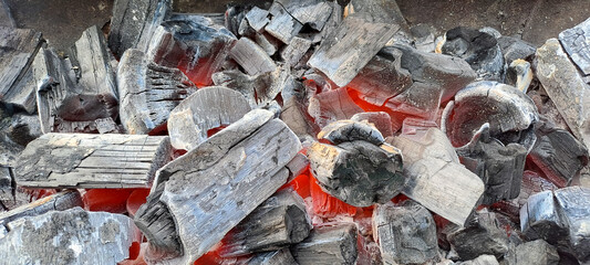 Closeup shot of a pile of charcoal with fire for a barbecue	
