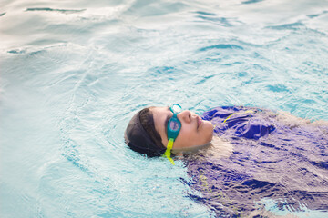 child swimming in the pool