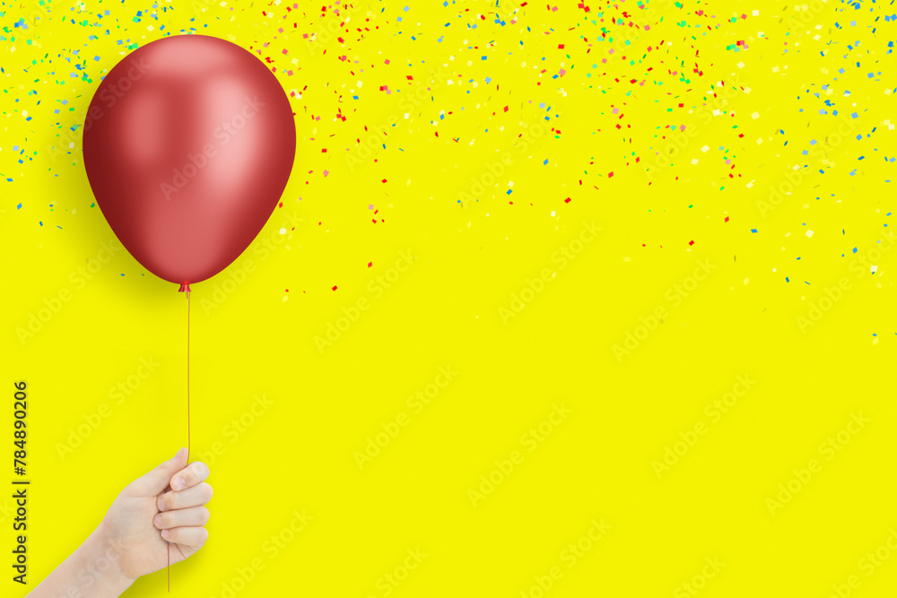 Poster female hand holding the red balloon on yellow background with confetti. empty space for text