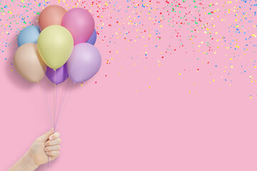 Female hand holds bunch of colorful balloons on pink background with confetti. Empty space for text - 784891214