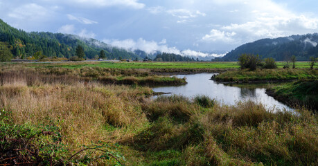 Panorama of the creek and surrounding mountains at the Dean Creek Wildlife Area near Reedsport,...