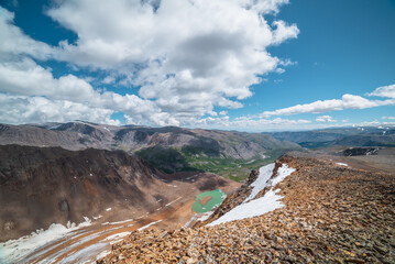 Picturesque top view from rocky precipice edge to glacier of unusual color and most beautiful...