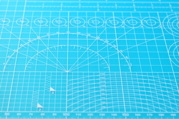blue cutting mat board background with line and scale measure guide pattern for object art design,...
