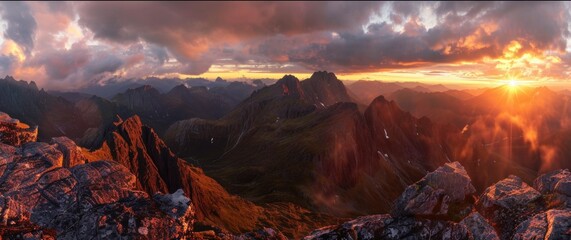 A panorama of a breathtaking sunset over a vast mountain range, showcasing the dramatic peaks bathed in warm light - obrazy, fototapety, plakaty