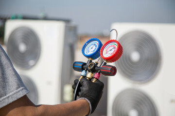 Technician use manifold gauge check and filling refrigerant vacuum pump evacuates industry air...