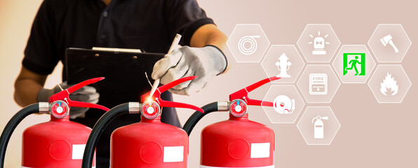 Hand checking fire extinguisher with fire protection icons for fire prevention protect and prevent...