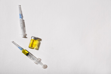 Medical syringes and ampoule on white background