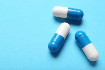 Colorful pills on blue background