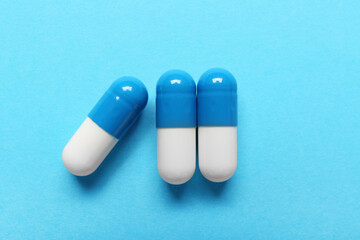 Colorful pills on blue background