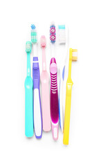 Colorful toothbrushes on white background
