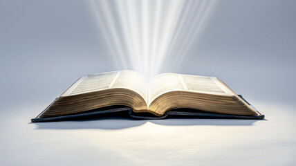 Open book with glowing pages on a reflective surface, rays of light emanating from the center.