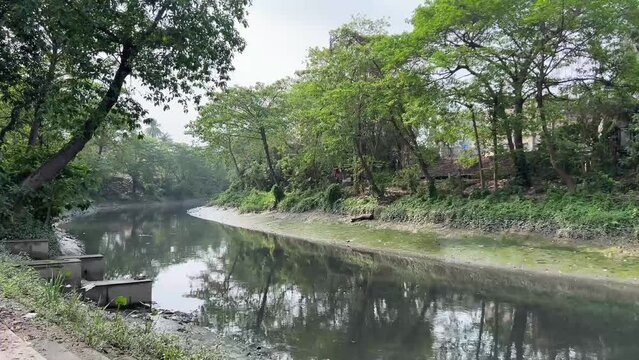 Profile view of Adi ganga in Kolkata, India. Cloudy day.