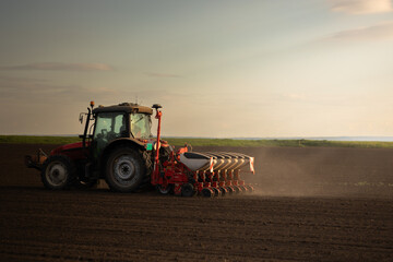 Farmer with tractor seeding - 784919867