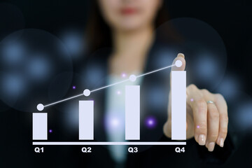 Unrecognizable good looking and smart businesswoman pointing her finger on the holographic or hologram bar chart showing a growth of business in quarter. Business concept. - obrazy, fototapety, plakaty