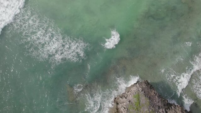 Drone video flying over small Island, water waves in Coastal Kenya