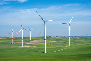 Wind turbines and green meadows seen in Italy - 784939456
