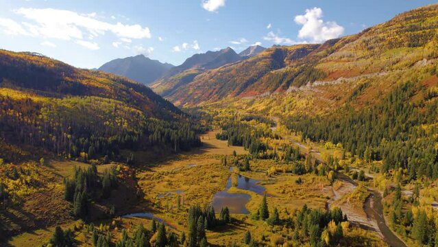 Drone Epic Landscape Autumn Yellow Aspen Trees McClure Pass Colorado Mountains. Winding rivers through mountain valley colorful trees.