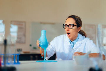 Chemist Mixing Substances making a Messy mistake in the Lab. Clumsy humorous research worker not knowing what she is doing
