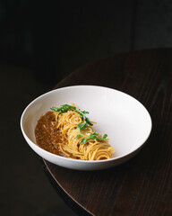 A delicious serving of spaghetti Bolognese: perfectly cooked pasta topped with rich, savory meat sauce. This classic Italian dish features a hearty blend of ground meat, tomatoes, and aromatic vegetab