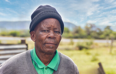 portrait of an old african man in the yard in south african village