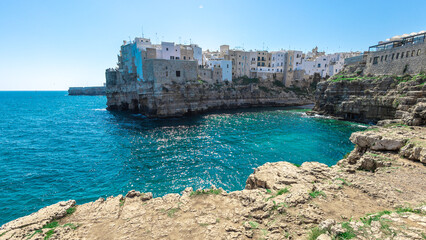Wide panorama of Polignano a mare, a beautiful city in Puglia, italy, on a sunny day. Visible beach...