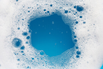 Naklejka premium Detergent foam bubble on wate. Blue background, Soap sud