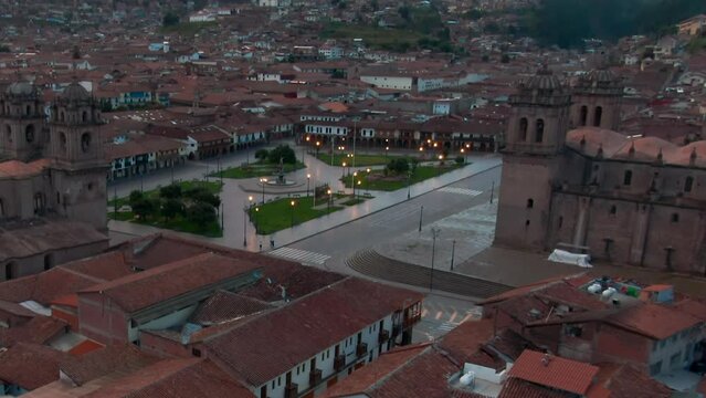 Plaza De Armas, Cusco Cathedral And Church of the Society of Jesus In Cusco, Peru. - aerial tilt up shot