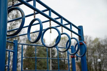 Blue gymnastic rings at sport playground