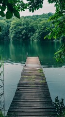 Obraz premium A wooden dock extends over the calm waters of a lake, providing a platform for boats to dock and people to enjoy the peaceful surroundings.