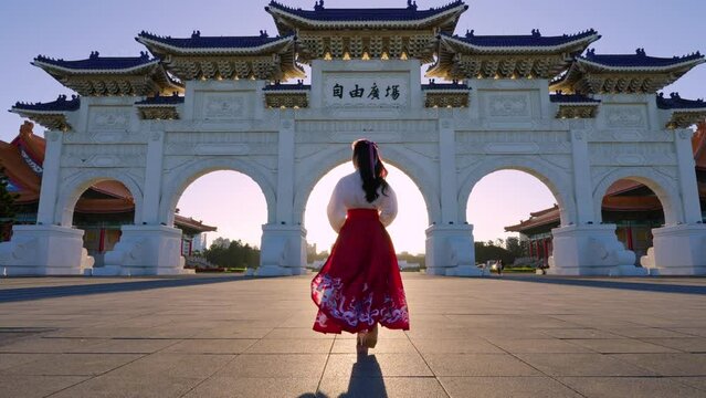 Slow motion video, Chiang Kai  Shek Memorial Arch with morning sunlight and Asian women in Taipei,Taiwan