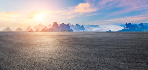 Asphalt road and karst mountain with sky clouds natural landscape at sunrise. Panoramic view.