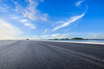 Asphalt highway road and sea with island natural landscape under the blue sky