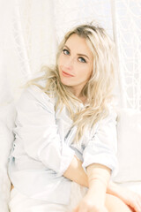 Naklejka premium Woman Sitting on White Couch