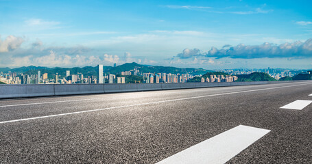 Asphalt highway road and city skyline with green mountain natural landscape in Shenzhen. Panoramic view.