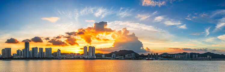 Beautiful coastline and city buildings scenery at sunset in Zhuhai. Panoramic view.