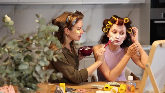 Process of applying mask to woman's face using brush 